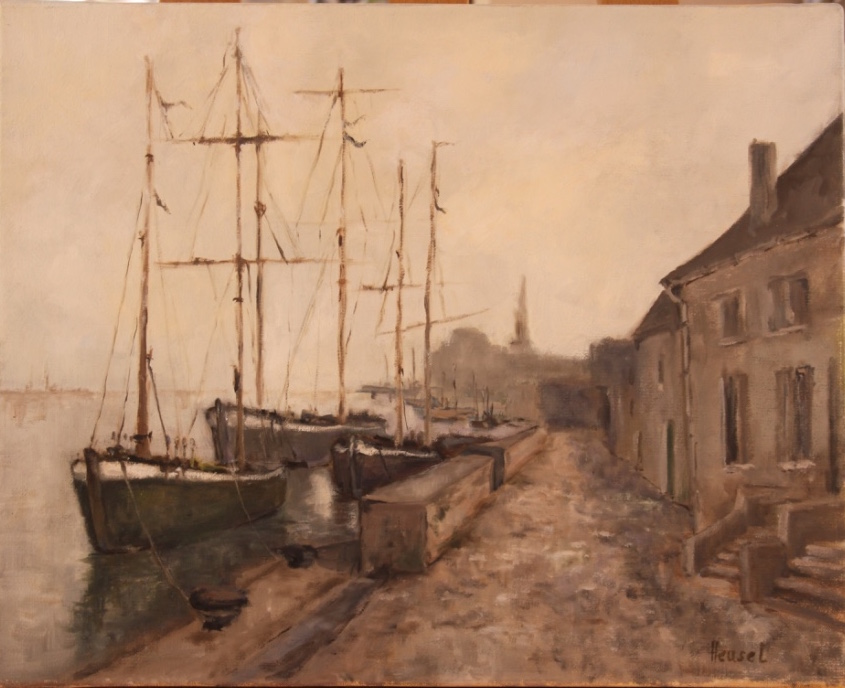 A photo of a sailboat moored in Brittany alongside a paved road.
